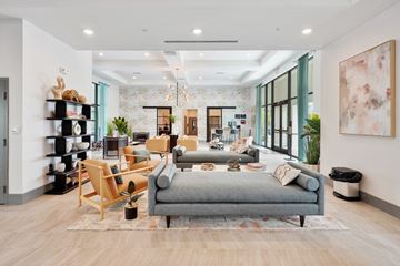 Fort Myers apartment for rent - A modern living room with a grey sofa and wooden floors.