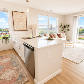 Kannapolis apartment for rent - Modern apartment kitchen at 200 Main Kannapolis featuring quartz countertops, white shaker cabinets, stainless steel appliances, and natural light.