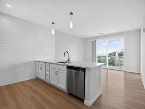 Kannapolis apartment for rent - A kitchen with white cabinets and a wooden floor.