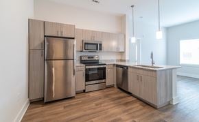 Concord apartment for rent - A modern kitchen with wooden cabinets and stainless steel appliances.