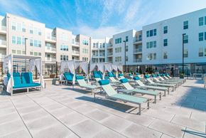 Kannapolis apartment for rent - Daybeds and umbrellas at pet-friendly apartments Kannapolis