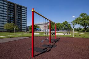 Rahway apartment for rent - a swing set in a park with a building in the background