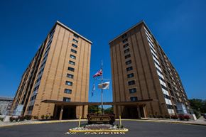 Rahway apartment for rent - two tall buildings with the flag in front of them