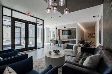 Bound Brook apartment for rent - A modern living room with a black leather couch and a white sofa.