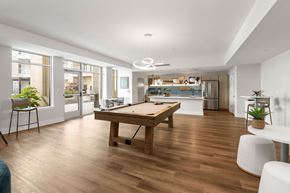 Concord apartment for rent - A stylish resident game lounge featuring a pool table, entertainment space, and modern gathering areas at NOVI Concord in Downtown Concord, NC.
