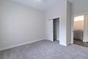 Concord apartment for rent - a bedroom with a closet and a door to a bathroom at Novi Rise, Concord, NC