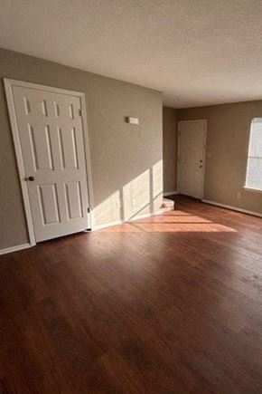 Bay City house for rent - A room with a white door and wooden flooring.