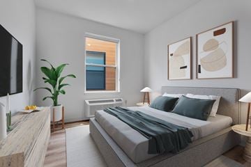 Jersey City apartment for rent - A modern bedroom with a large bed and a flat screen TV.