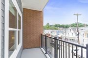 Wharton apartment for rent - A balcony with a black railing and a brick wall at 10 N. Main Apartments, Wharton, New Jersey