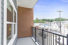 Wharton apartment for rent - A balcony with a black railing and a brick wall at 10 N. Main Apartments, Wharton, New Jersey