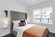 Wharton apartment for rent - A bedroom with a large bed and a window overlooking a balcony. at 10 N. Main Apartments, Wharton 07885