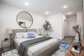 Bloomfield apartment for rent - a white bedroom with a large bed and a mirror
