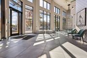 Hackensack apartment for rent - A sunny day at the lobby of a building with a bicycle hanging on the wall.