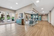 Hackensack apartment for rent - A spacious room with wooden floors and glass walls.