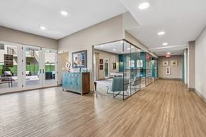 Hackensack apartment for rent - A spacious room with wooden floors and glass walls.