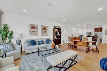 Whippany apartment for rent - A living room with a white couch and a blue ottoman.