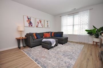 Carteret apartment for rent - A living room with a grey couch and a rug.