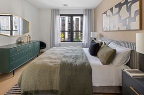 Teaneck apartment for rent - A bedroom with a large bed and a large window.