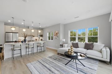Livingston apartment for rent - A modern living room with a white sofa and a grey rug.