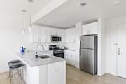 Plainfield apartment for rent - A modern kitchen with white cabinets and stainless steel appliances.