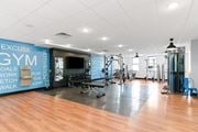 Plainfield apartment for rent - A gym with a variety of equipment and a wall with exercise motivation words.