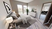 Hackensack apartment for rent - A bedroom with a bed, nightstand, and a plant at Crossroads 389 Apartments, Hackensack, NJ