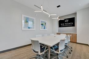 Bloomfield apartment for rent - a conference room with a white table and chairs