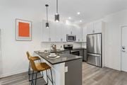 Jersey City apartment for rent - A kitchen with a table and chairs and a fridge.at 829 Garfield, Jersey City, NJ 07305