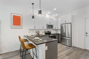 Jersey City apartment for rent - A kitchen with a table and chairs and a fridge.at 829 Garfield, Jersey City, NJ 07305