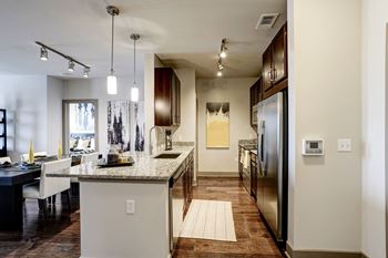 Opulent track lighting in kitchen & dining area