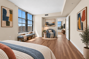 Arlington apartment for rent - A bedroom with a large bed and a view of the city.