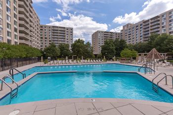 Olympic-sized pool with swimming lanes, free swim area, and expansive sundeck with chaise lounge chairs 