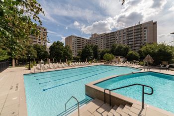 Olympic-sized pool with swimming lanes, free swim area, and expansive sundeck with chaise lounge chairs 