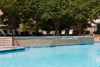 Olympic-sized pool with swimming lanes, free swim area, and expansive sundeck with chaise lounge chairs 