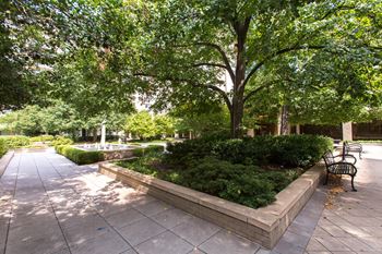 Grand apartment community with sprawling central courtyard connecting two apartment towers and ample amenities 