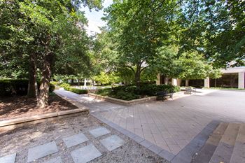 Grand apartment community with sprawling central courtyard connecting two apartment towers and ample amenities 