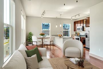 Herndon apartment for rent - A modern living room with a white couch and a coffee table.