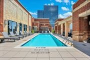 Arlington apartment for rent - A pool surrounded by brick buildings with a sign that says