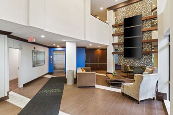 Modern lobby with transit screen and seating areas 