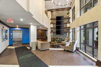 Modern lobby with transit screen and seating areas 