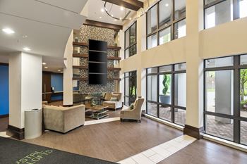 Modern lobby with transit screen and seating areas 