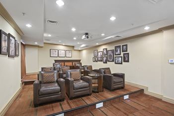Home theater with full sized leather recliner chairs for private viewings 