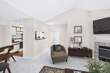 Woodbridge apartment for rent - a living room with a couch and a chair and a fireplace