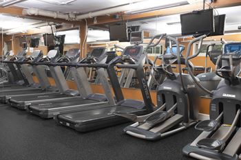 24-Hr. Fitness center with cardio machines and free weights 