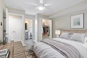 Arlington apartment for rent - A bedroom with a large bed and a ceiling fan.