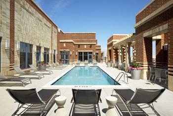 Rooftop pool and sundeck with outdoor seating areas