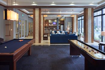 Elaborate clubroom equipped with full kitchen, bar, billiards table and more