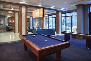 Elaborate clubroom equipped with full kitchen, bar, billiards table and more
