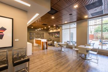 Stylish clubroom with kitchen, social seating areas, and work from home spaces 