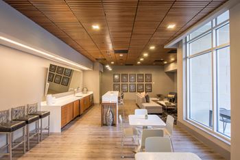 Stylish clubroom with kitchen, social seating areas, and work from home spaces 